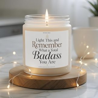 Light This and Remember What a Total Badass You Are 9 oz soy candle label with elegant black and brown typography, small flame icon, and minimalist cream background.